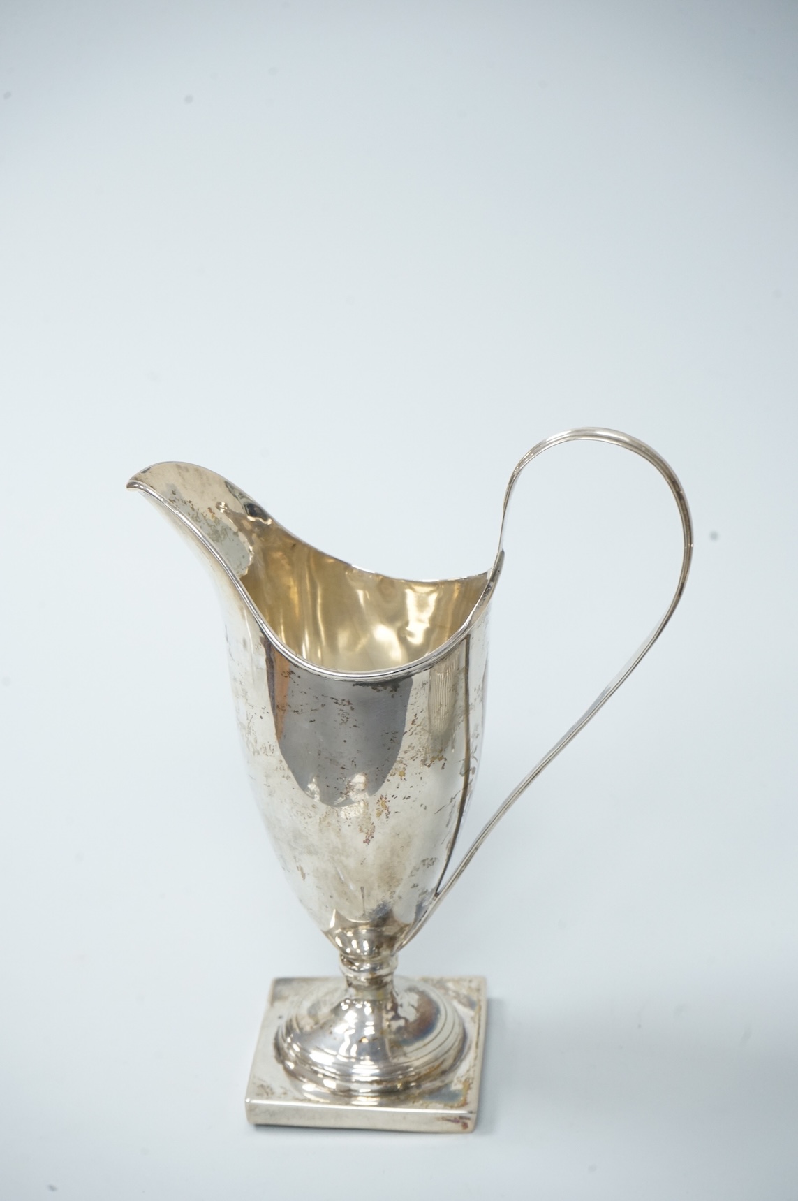A late Victorian silver sugar basin, by Robert Harper, London, 1879, diameter 13.2cm, together with an Edwardian silver helmet shaped cream jug, Saunders & Shepherd, Chester, 1905, 15cm, 9.1oz.